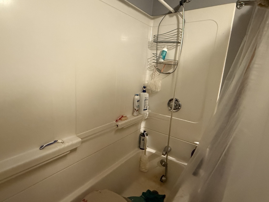 73-75 Draper Avenue Mansfield, MA 02048 - Photo 12 of 21 a bathroom with a shower and toilet