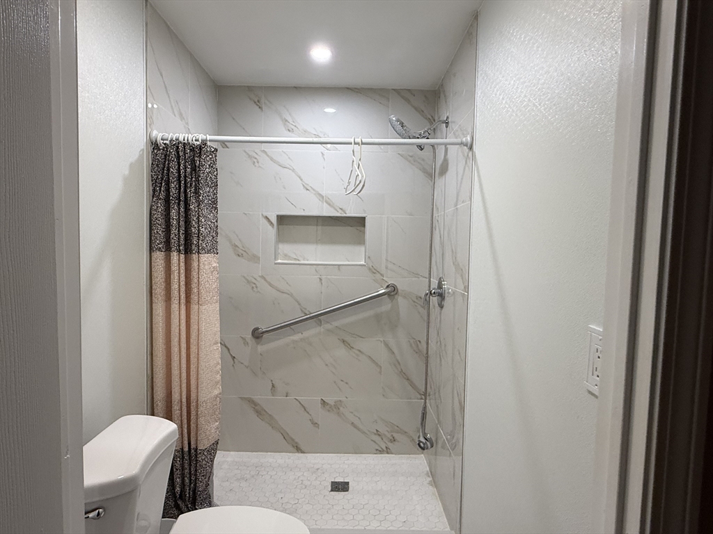 73-75 Draper Avenue Mansfield, MA 02048 - Photo 9 of 21 a bathroom with a shower and a toilet