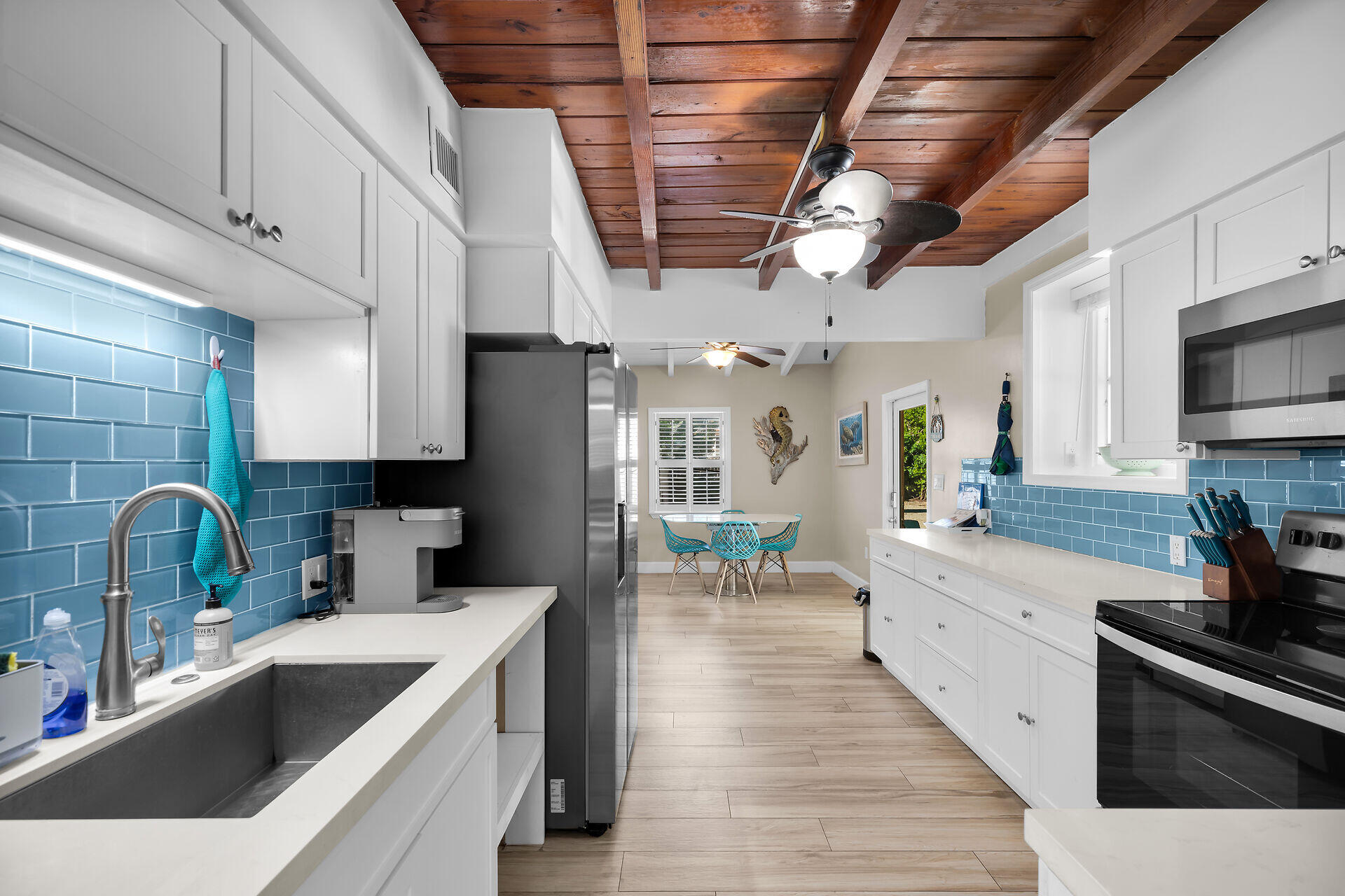 28 Tarpon Avenue Key Largo, FL 33037 - Photo 20 of 42 a kitchen with stainless steel appliances granite countertop a sink a stove and a wooden floors