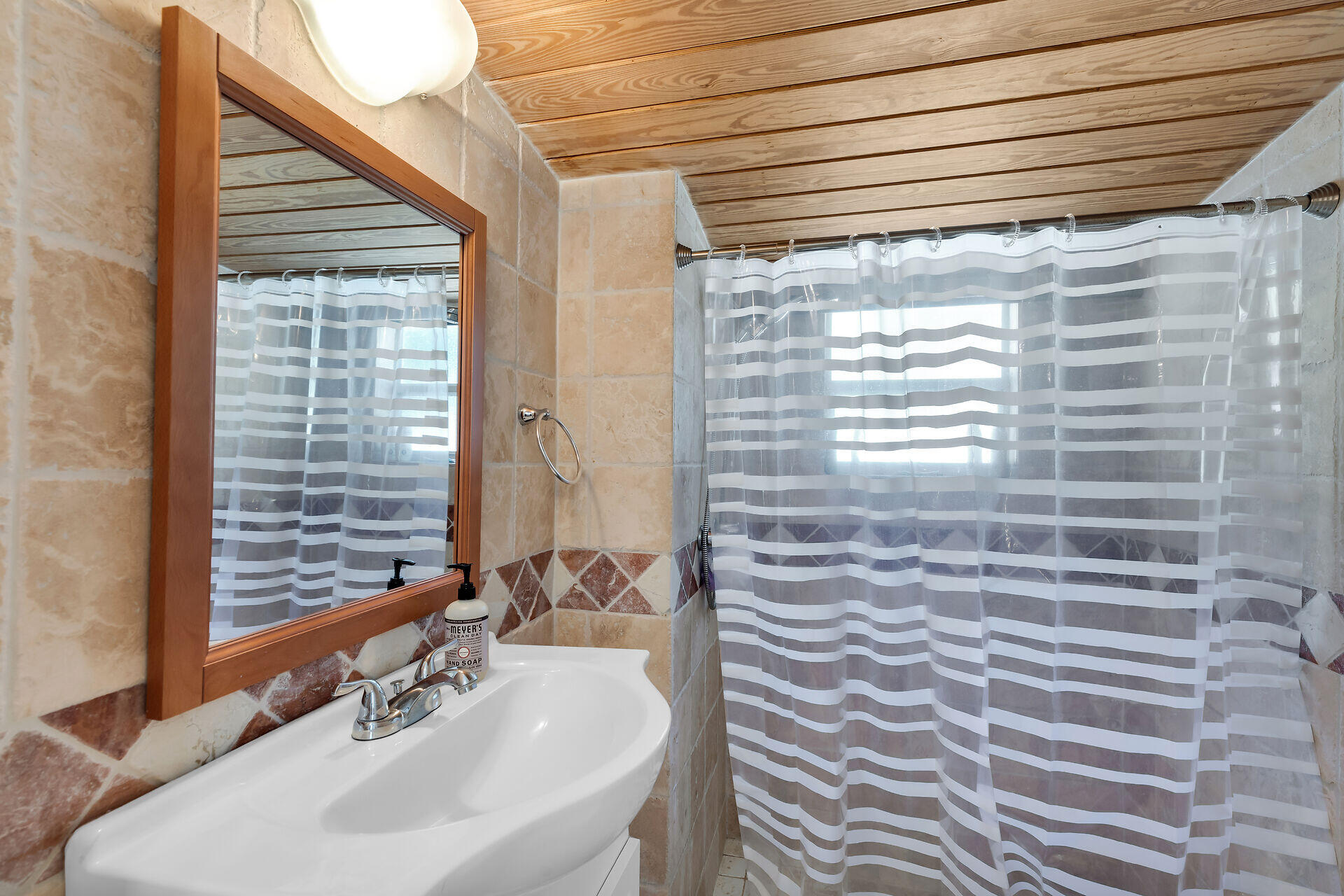 28 Tarpon Avenue Key Largo, FL 33037 - Photo 23 of 42 a bathroom with a sink a mirror and a shower