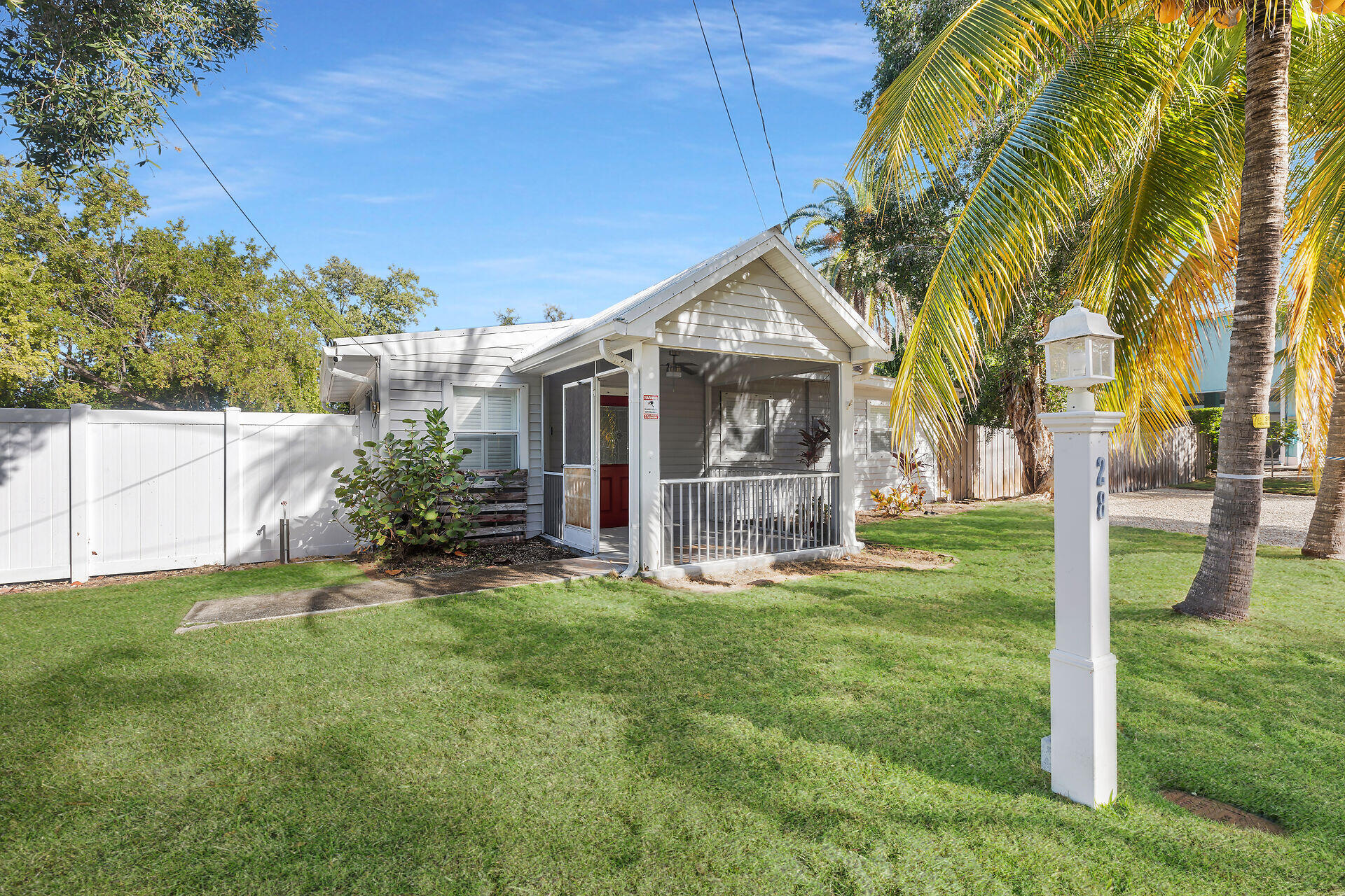 28 Tarpon Avenue Key Largo, FL 33037 - Photo 7 of 42 a view of a house with a yard and plants