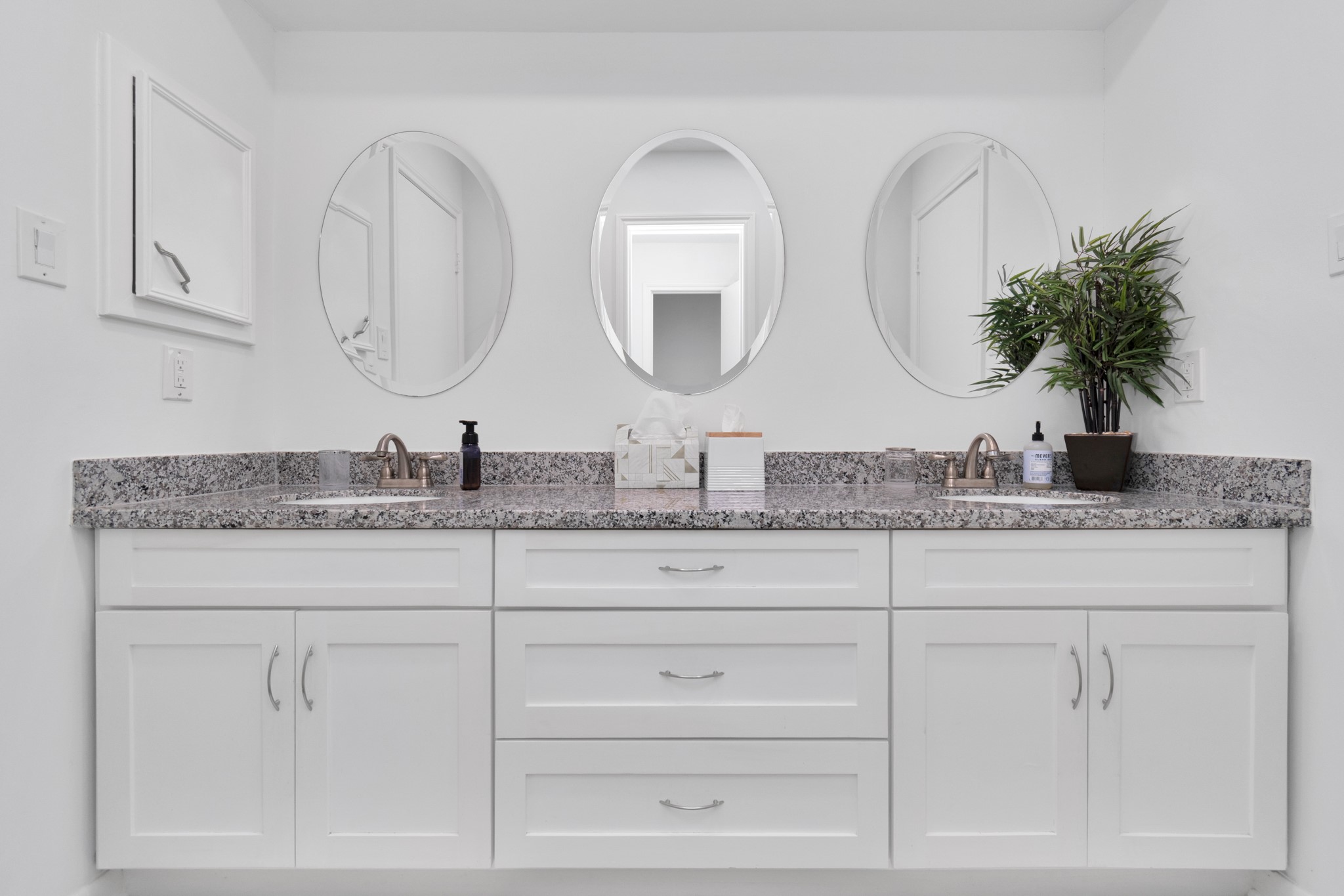 2718 Lazy Spring Drive Houston, TX 77080 - Photo 22 of 32 Shared Jack and Jill bathroom with a dual-sink vanity, granite countertop, and white cabinetry. Three mirrors and a functional layout make it great for shared use.