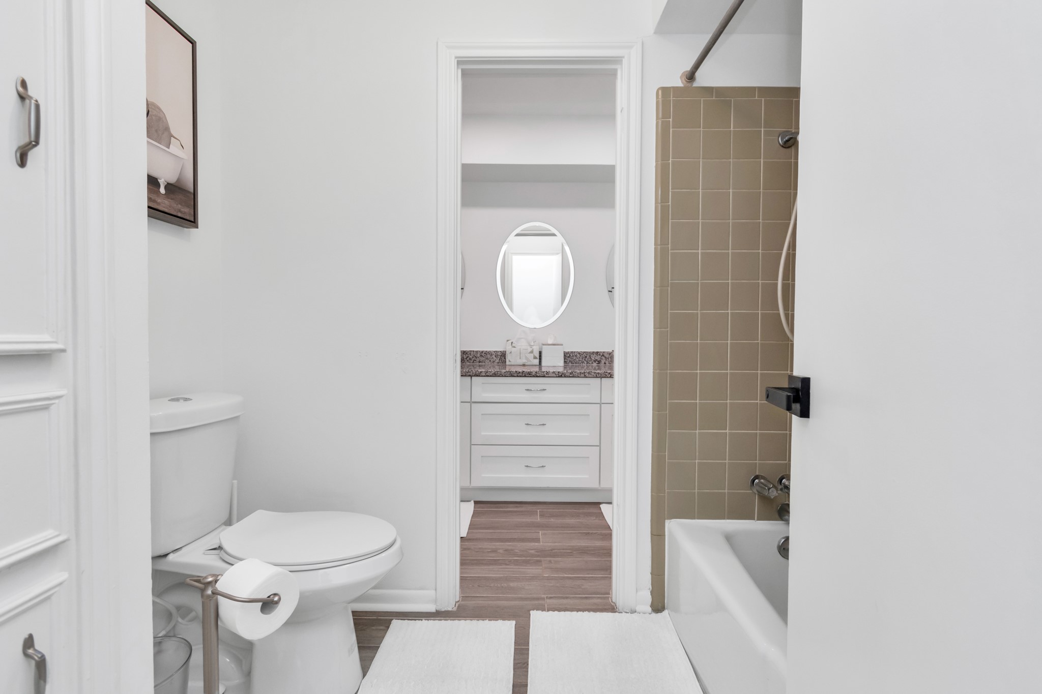 2718 Lazy Spring Drive Houston, TX 77080 - Photo 24 of 32 Private bath area with a shower/tub combo, toilet, and linen cabinet for extra storage. Accessible from both bedrooms in the Jack and Jill layout, as well as the hallway for guests and the fourth bedroom.