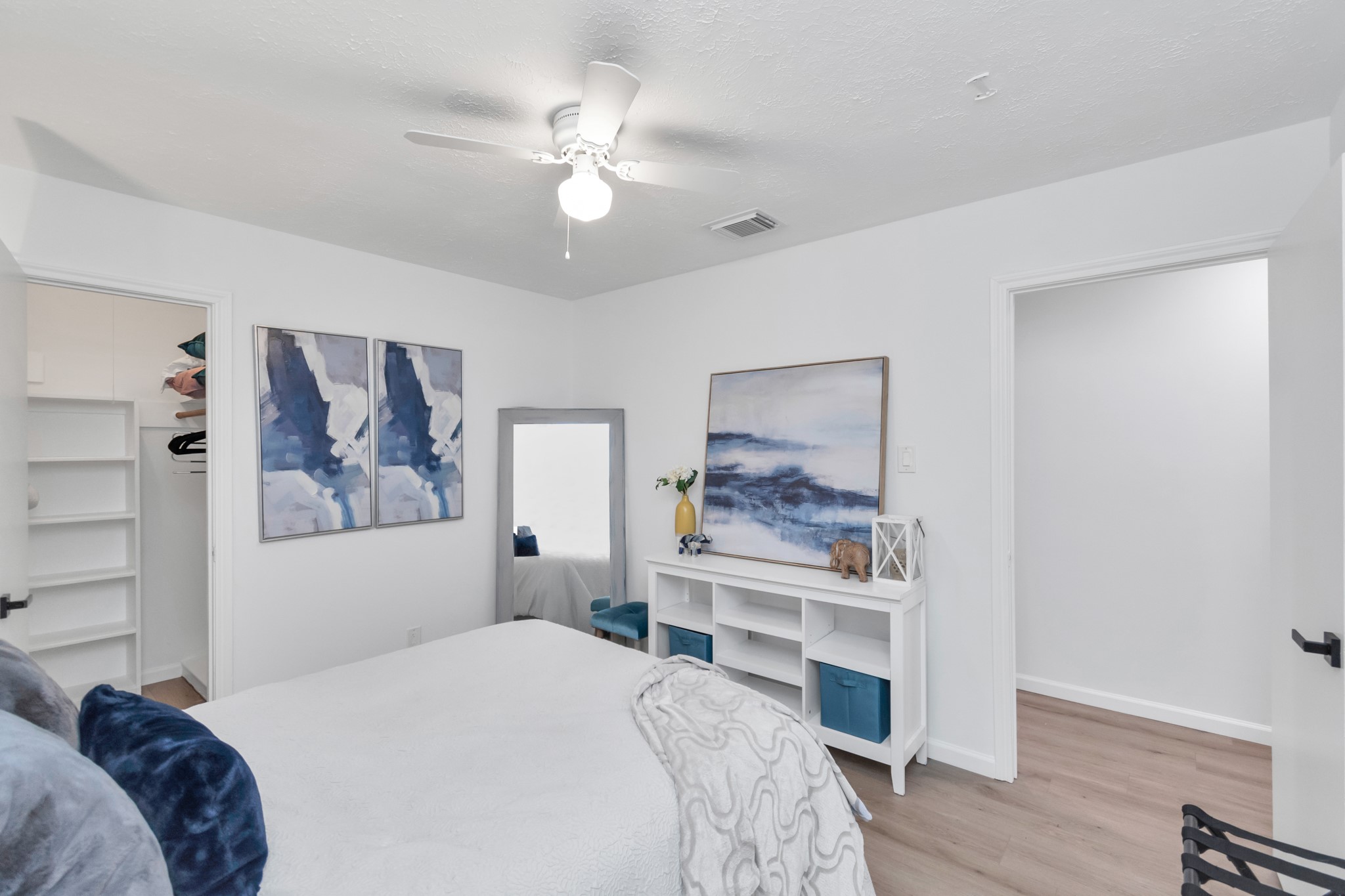 2718 Lazy Spring Drive Houston, TX 77080 - Photo 25 of 32 Secondary bedroom with white oak-look LVP flooring, a ceiling fan, and a walk-in closet. Comfortable layout with great everyday function.