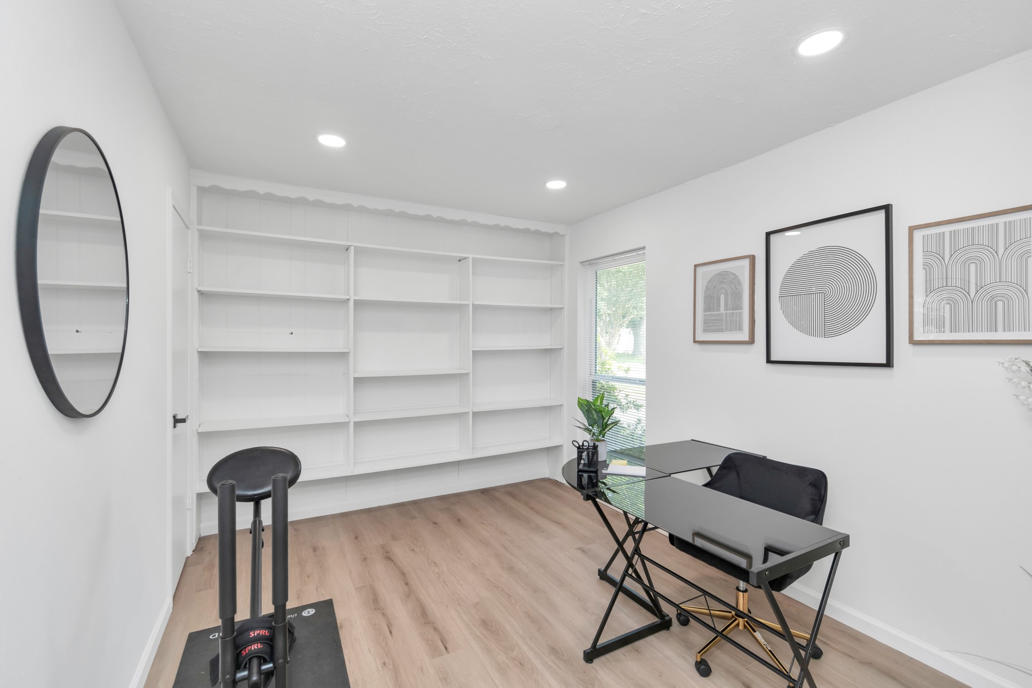 2718 Lazy Spring Drive Houston, TX 77080 - Photo 27 of 32 Secondary bedroom with white oak-look LVP flooring, built-in shelving, and a large walk-in closet. Flexible space for a bedroom, home office, or hobby room.