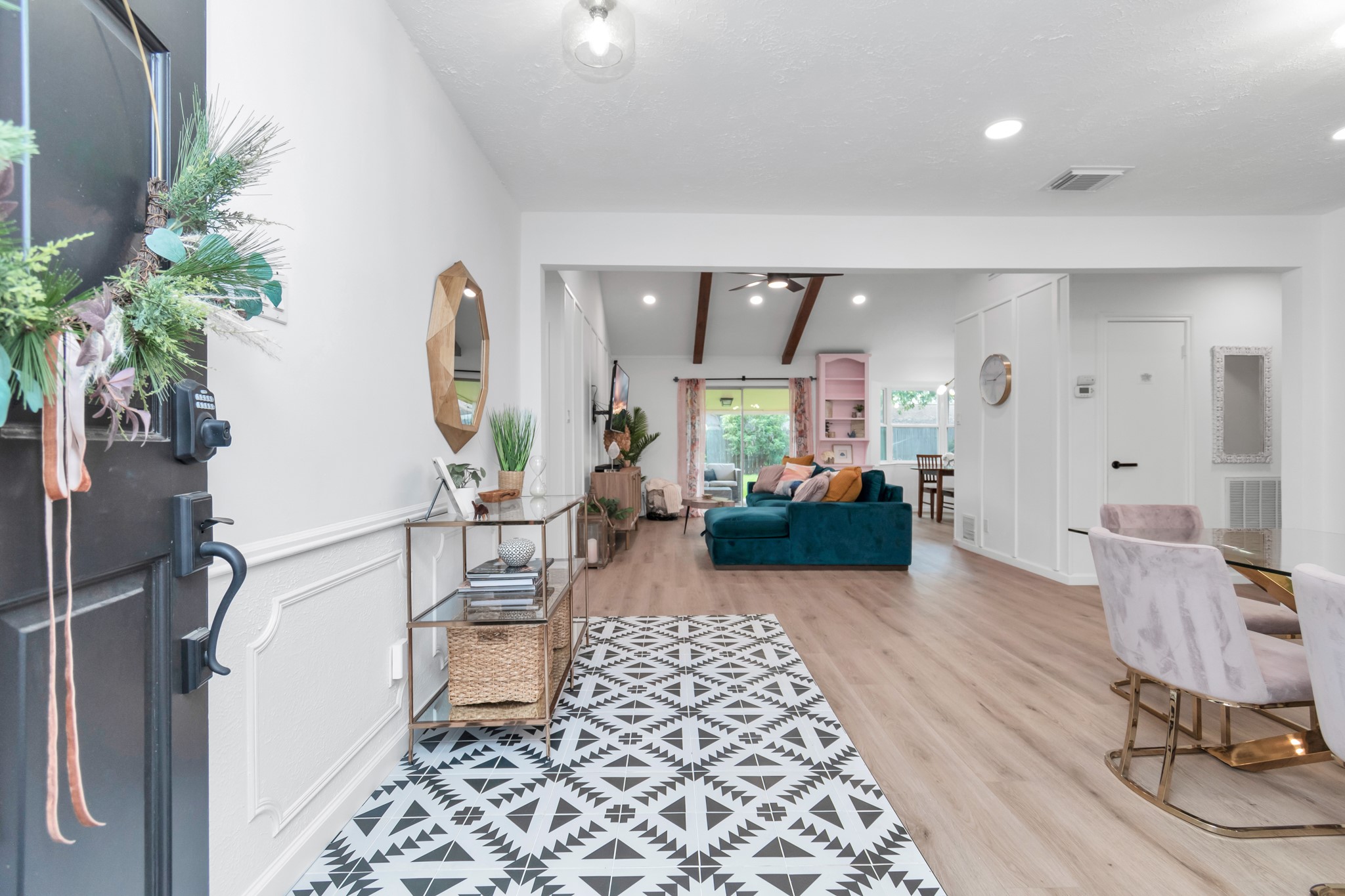 2718 Lazy Spring Drive Houston, TX 77080 - Photo 5 of 32 Welcoming entry with a stylish patterned floor that opens to a bright, open living area. Vaulted ceilings with wood beams and natural light create a warm feel. Flows into a cozy living space and modern dining area.
