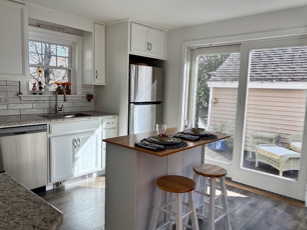 21 Highland Park Road Rutland, MA 01543 - Photo 12 of 41 a kitchen with stainless steel appliances granite countertop a sink stove and refrigerator