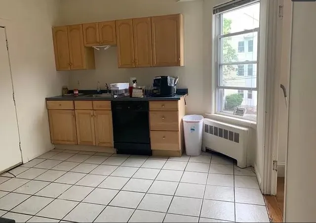 a kitchen with a cabinets a sink and a stove top oven