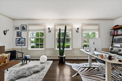 a living room with furniture and large windows