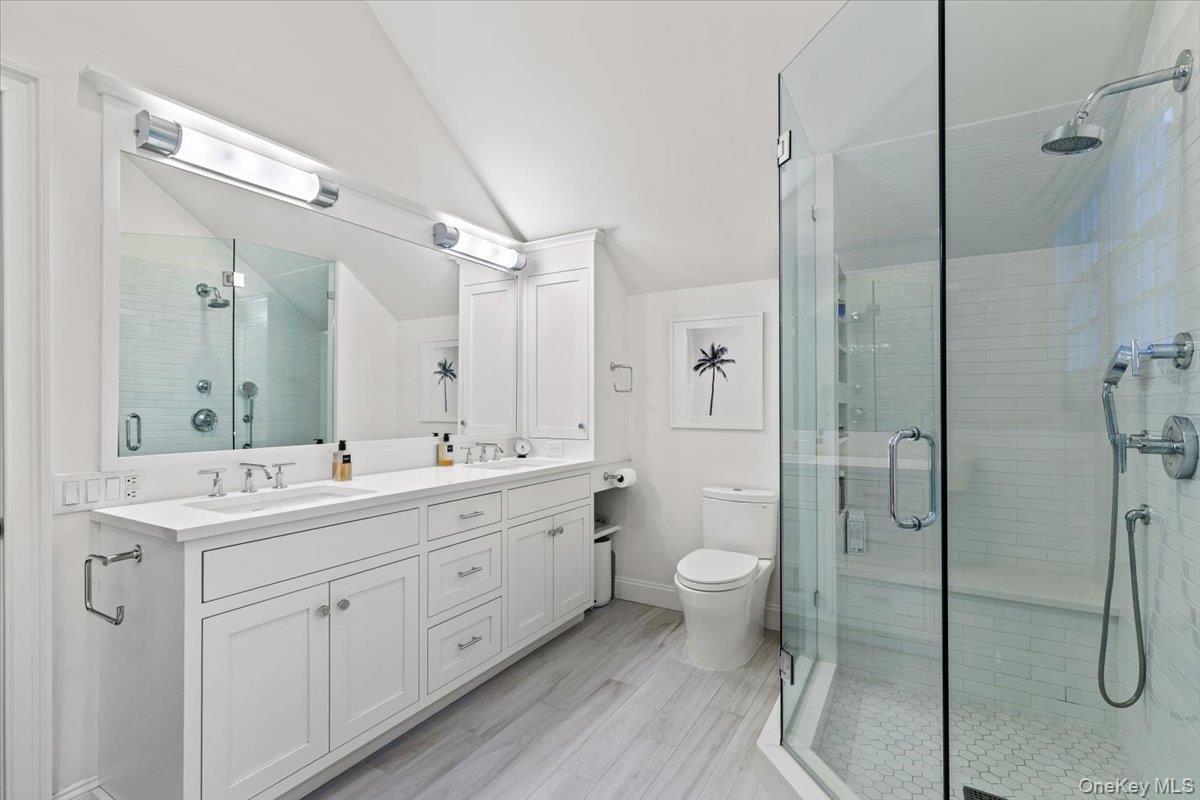 4 Martin Road Rye, NY 10580 - Photo 13 of 28 a spacious bathroom with a double vanity sink toilet mirror and shower