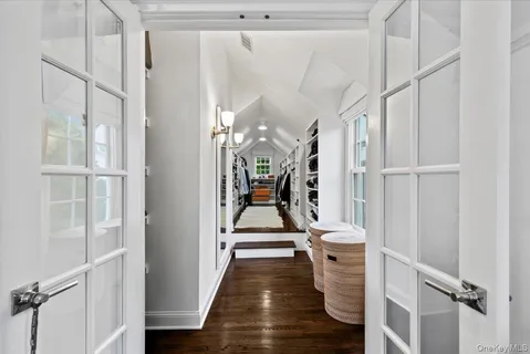 a view of a hallway with wooden floor and staircase
