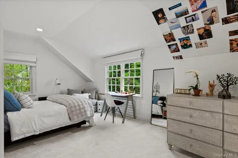 a bed room with a bed and a chair