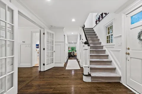a view of entryway and hall with wooden floor
