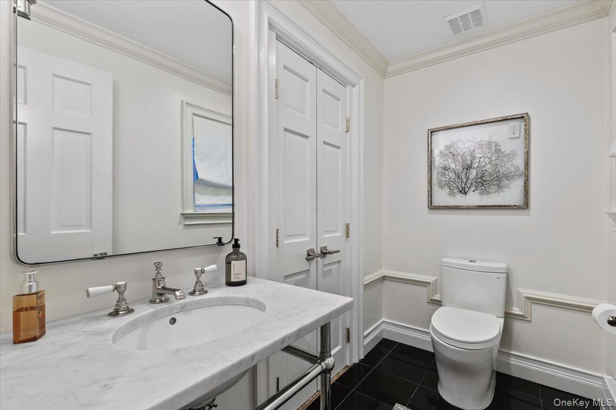 4 Martin Road Rye, NY 10580 - Photo 6 of 28 a bathroom with a toilet a sink and mirror