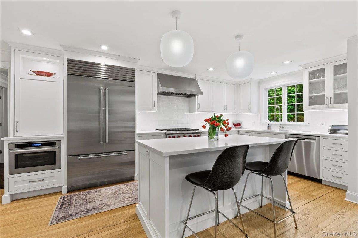 4 Martin Road Rye, NY 10580 - Photo 7 of 28 a kitchen with stainless steel appliances a dining table chairs stove and refrigerator