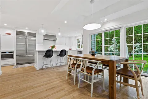 a view of a dining room with furniture window and wooden floor