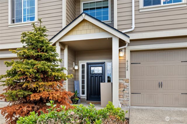 front view of a house with a potted plant