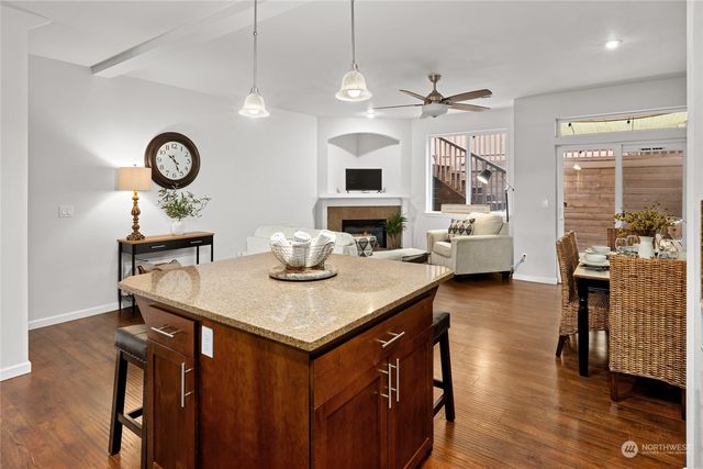 a kitchen with a table chairs microwave and cabinets