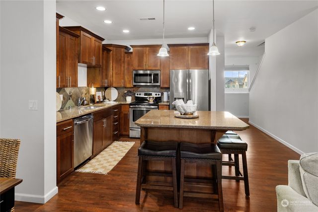 a dining room with furniture and wooden floor