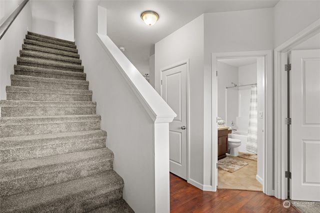 a room with wooden floor and a ceiling fan