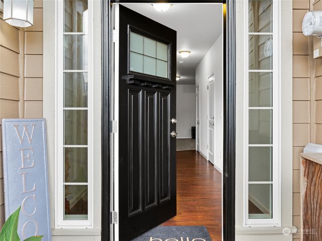 a view of a hallway with wooden floor and entryway