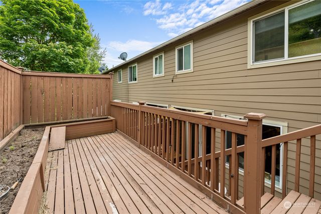 aerial view of a house with a yard and green space