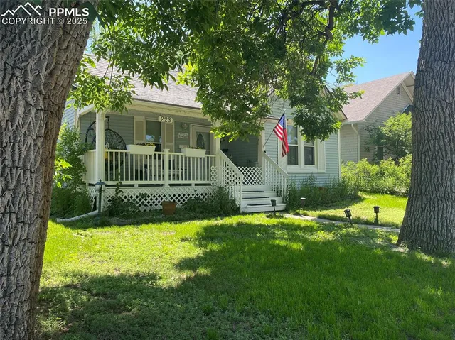 a view of a house with a yard and a garden
