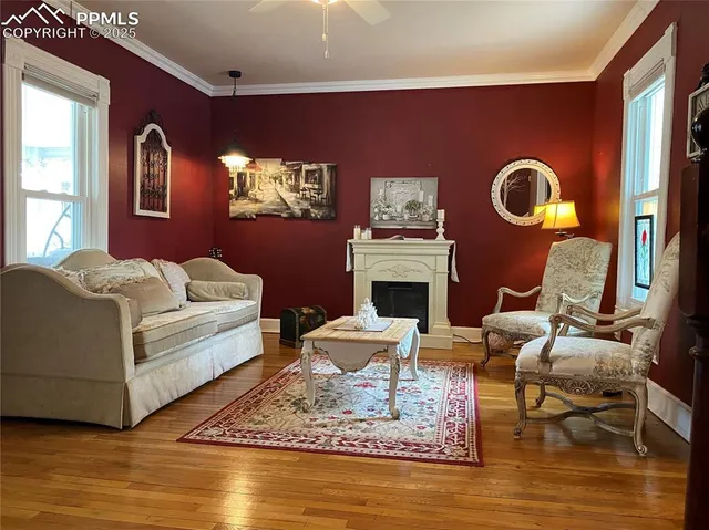a living room with furniture and painting on the wall