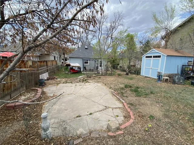 a view of a house with a yard covered in snow