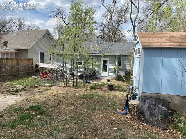 a view of a house with backyard and sitting area