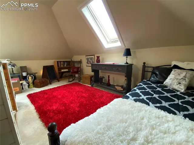 a bedroom with bed and a fireplace