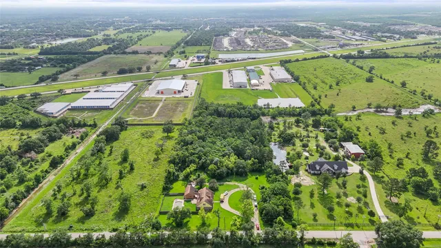 an aerial view of residential houses with outdoor space and swimming pool