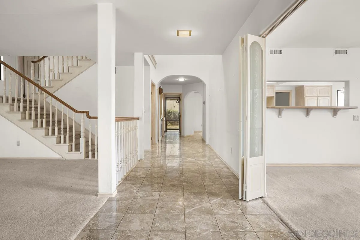 3130 Goldfinch Street San Diego, CA 92103 - Photo 11 of 59 a view of a hallway with wooden floor and staircase