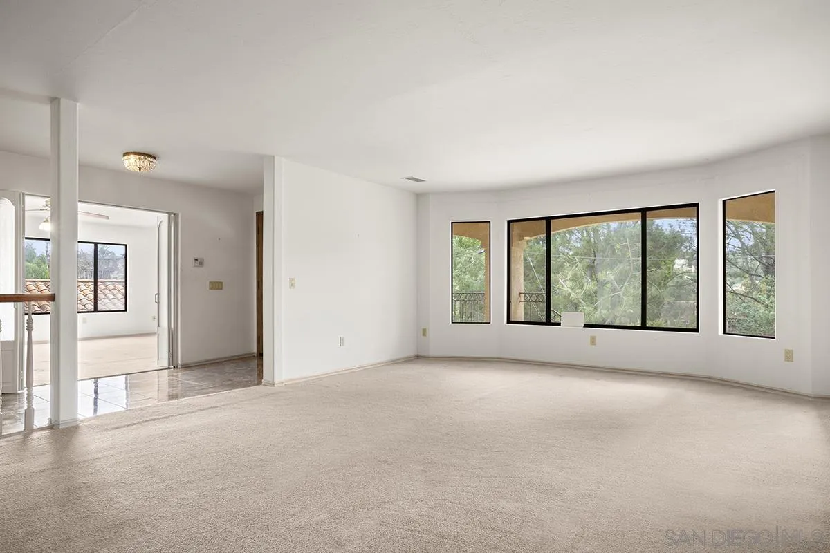 3130 Goldfinch Street San Diego, CA 92103 - Photo 12 of 59 a view of a big room with windows and chandelier fan