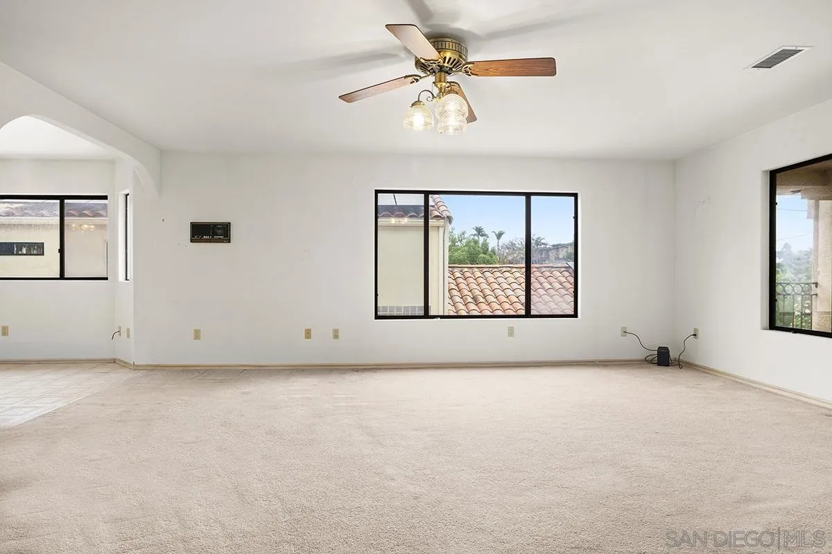 3130 Goldfinch Street San Diego, CA 92103 - Photo 14 of 59 an empty room with windows and fan