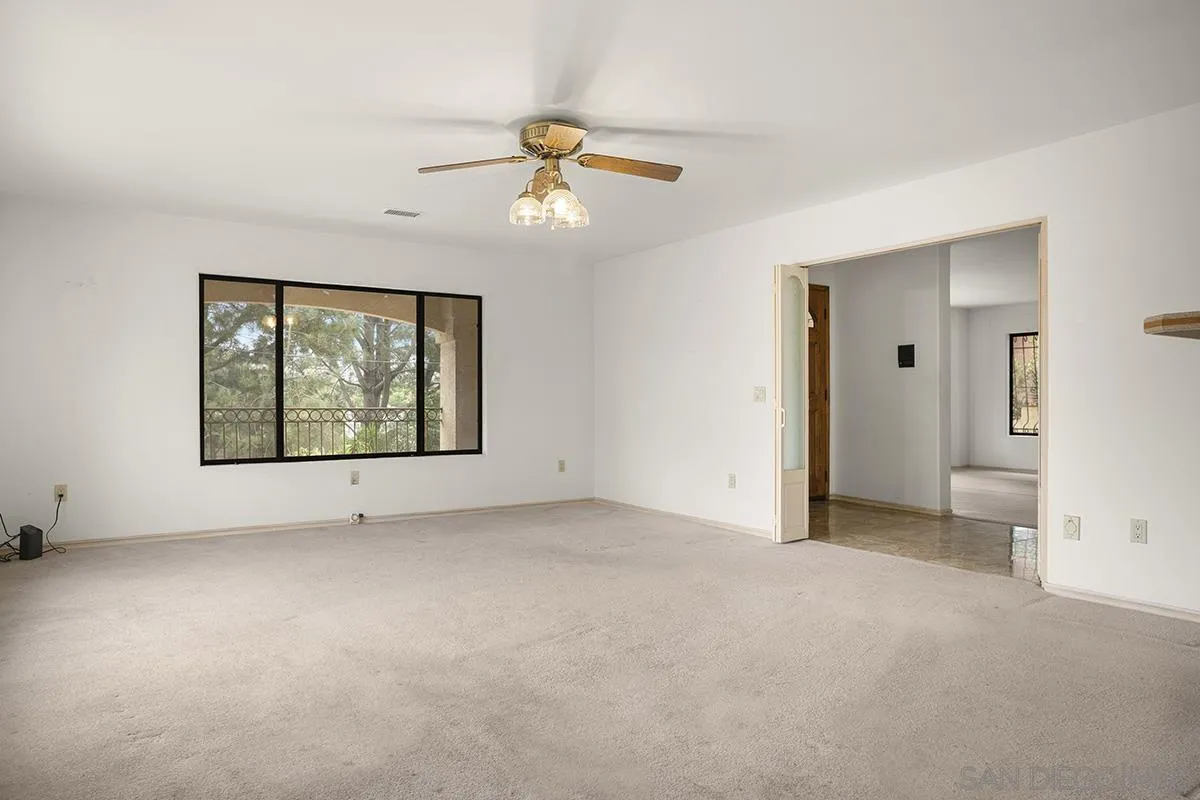 3130 Goldfinch Street San Diego, CA 92103 - Photo 18 of 59 an empty room with windows and fan