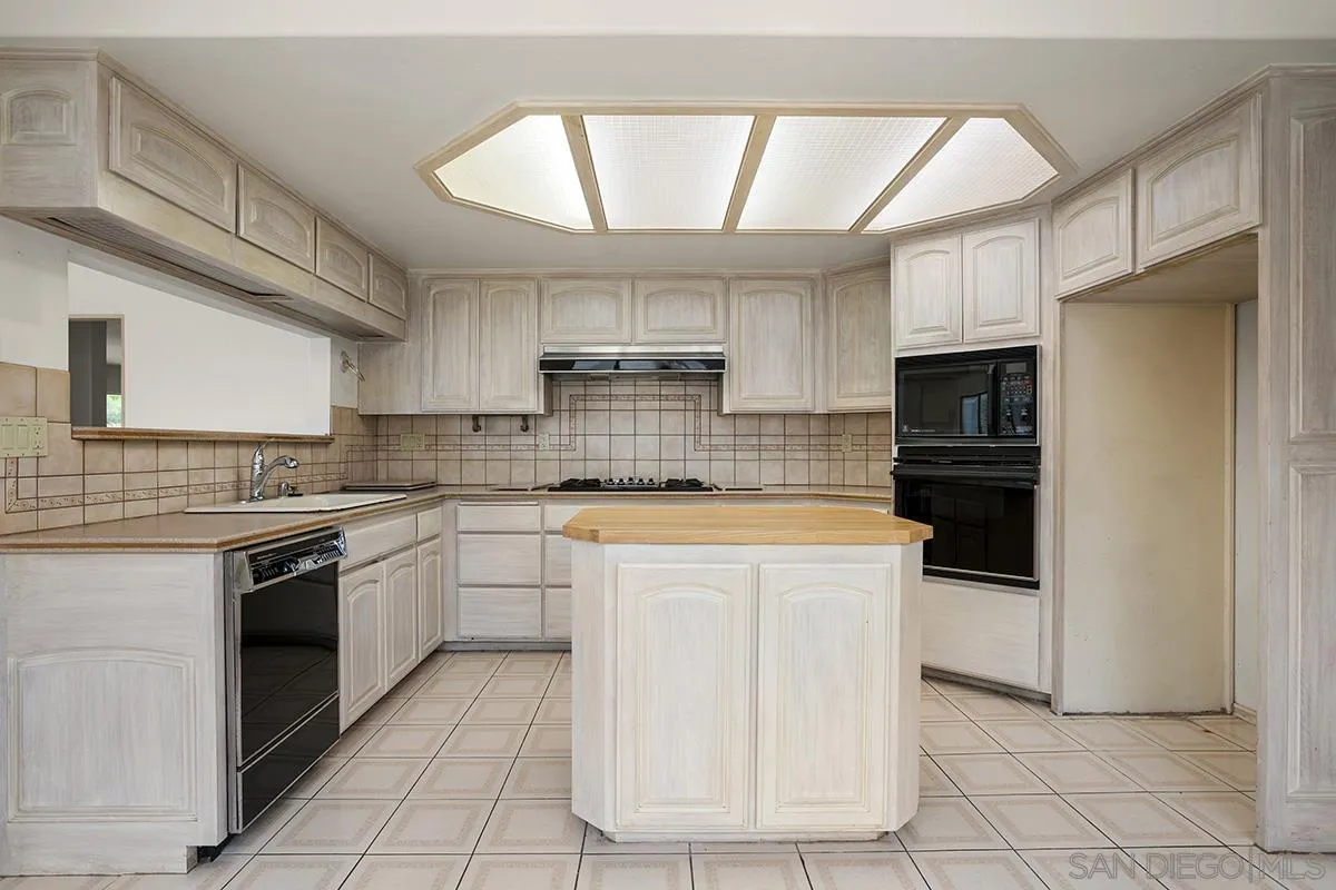 3130 Goldfinch Street San Diego, CA 92103 - Photo 21 of 59 a kitchen with stainless steel appliances granite countertop a stove and a refrigerator