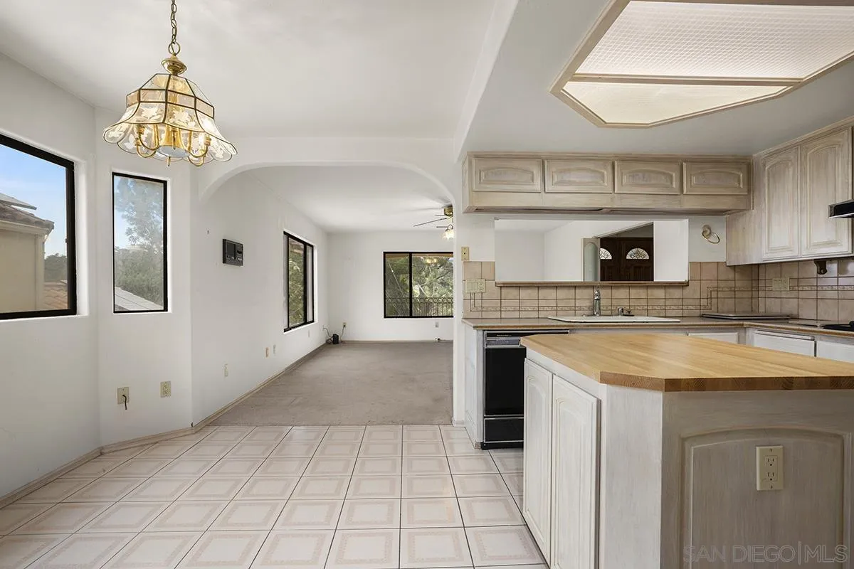 3130 Goldfinch Street San Diego, CA 92103 - Photo 24 of 59 a kitchen with a sink a counter top space and a fireplace