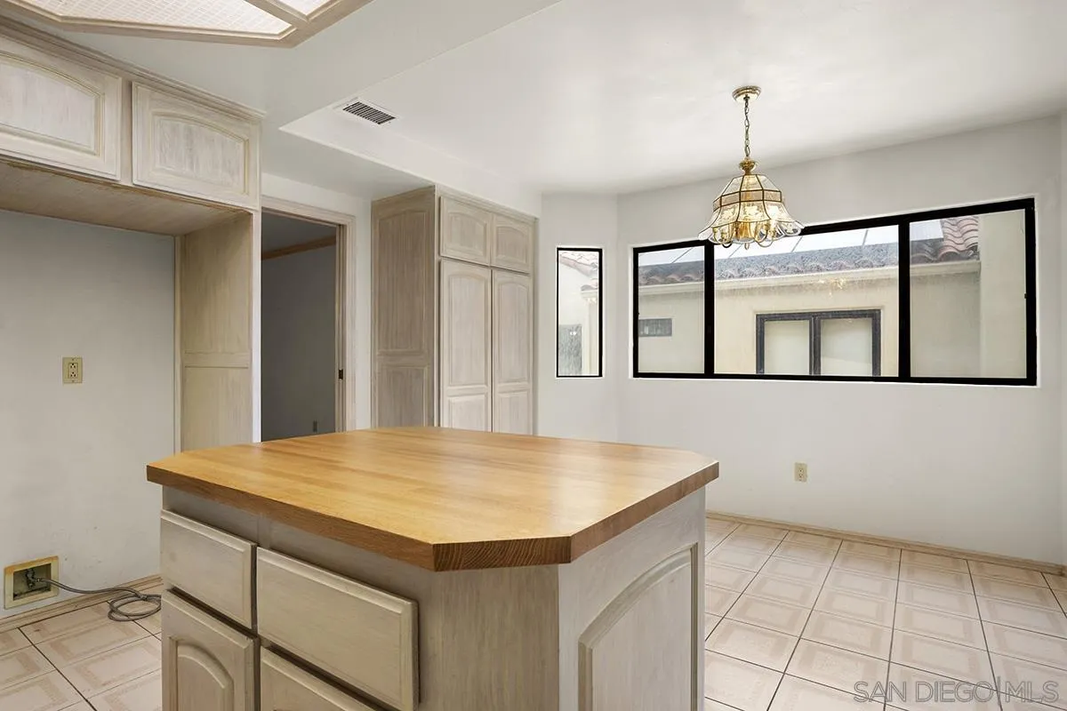 3130 Goldfinch Street San Diego, CA 92103 - Photo 25 of 59 a kitchen with a table chairs and refrigerator