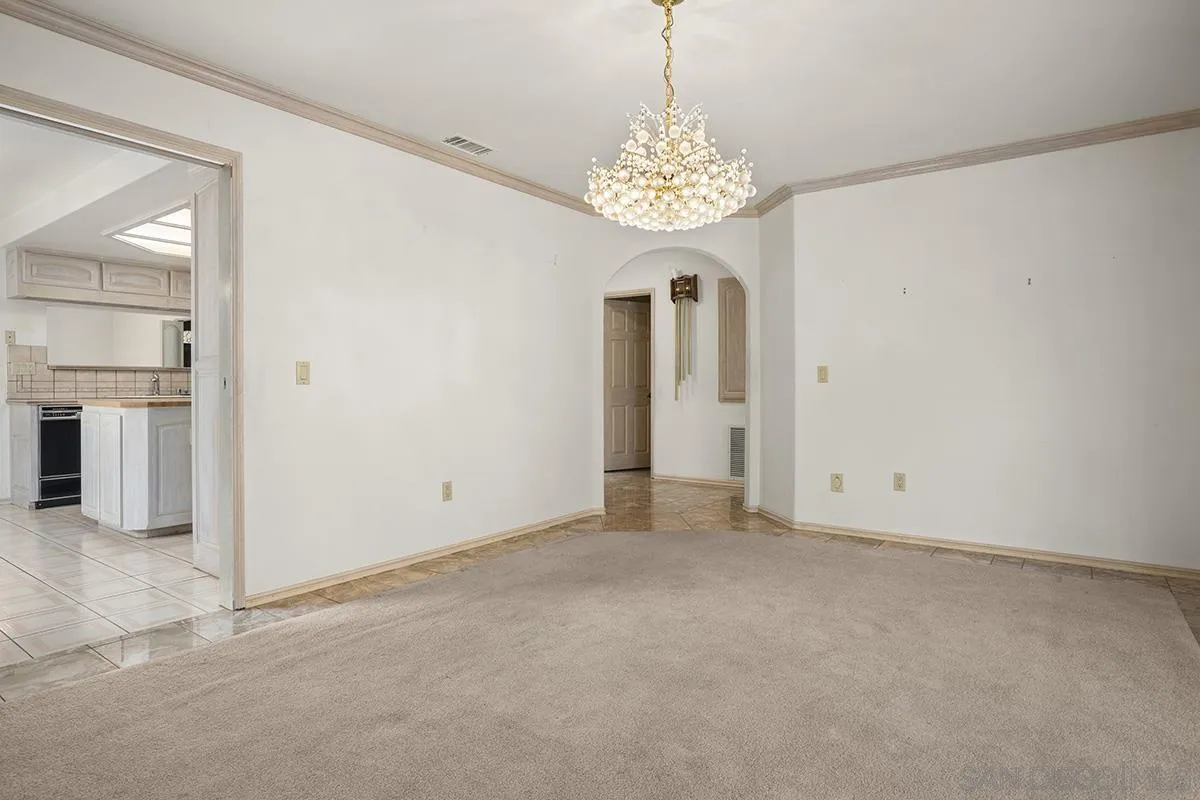 3130 Goldfinch Street San Diego, CA 92103 - Photo 26 of 59 an empty room with chandelier