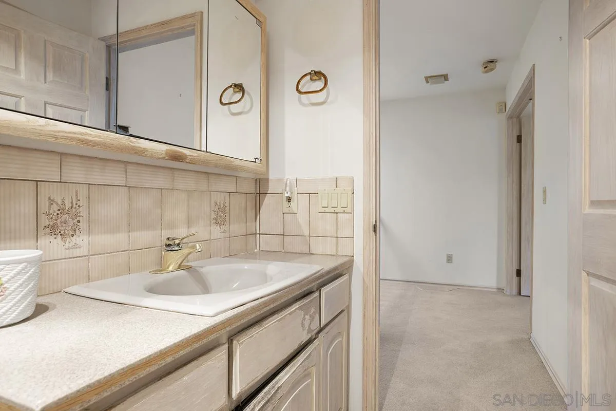 3130 Goldfinch Street San Diego, CA 92103 - Photo 35 of 59 a bathroom with a sink and a mirror