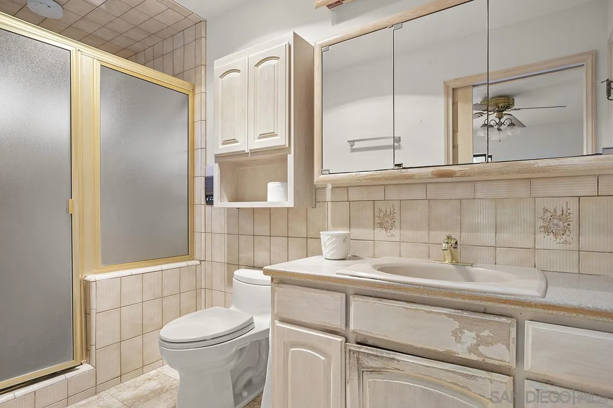 3130 Goldfinch Street San Diego, CA 92103 - Photo 36 of 59 a bathroom with a sink toilet and shower