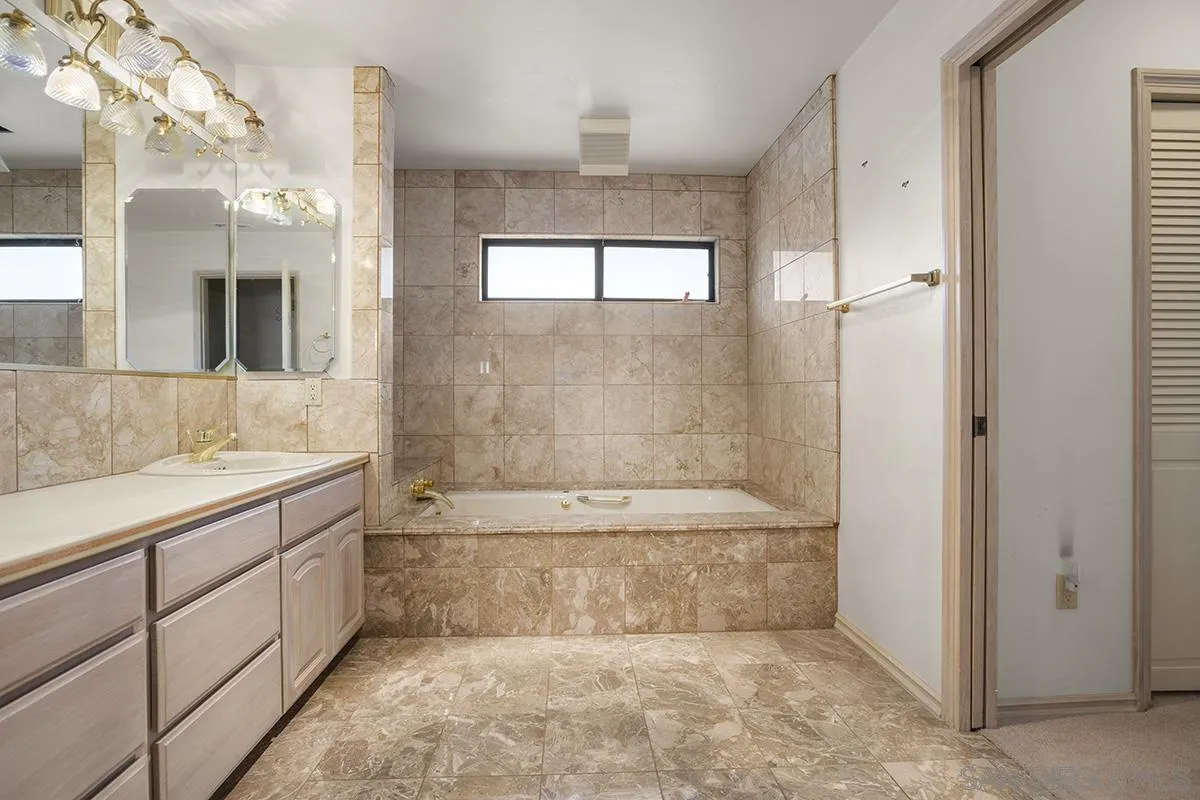 3130 Goldfinch Street San Diego, CA 92103 - Photo 37 of 59 a bathroom with a bathtub shower and sink