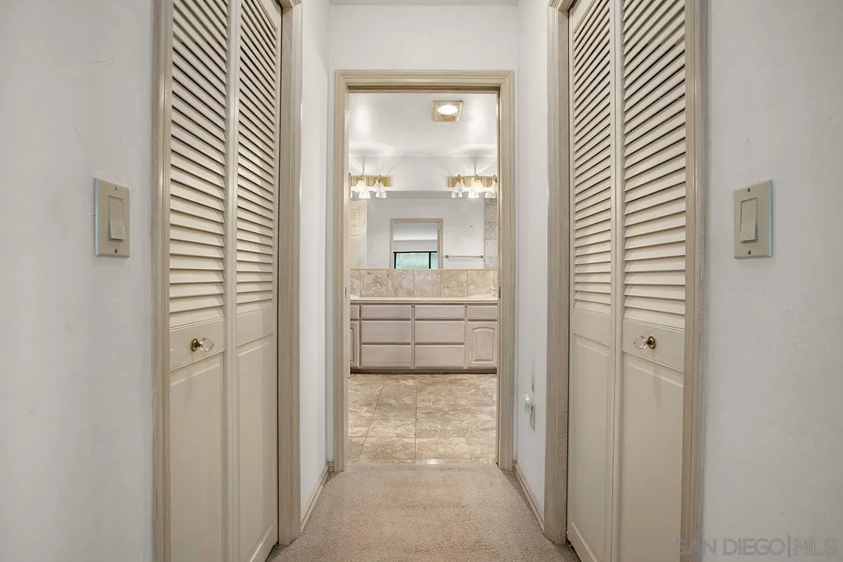 3130 Goldfinch Street San Diego, CA 92103 - Photo 38 of 59 a view of a hallway with a door and a bathroom