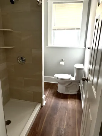 a bathroom with a toilet and a window