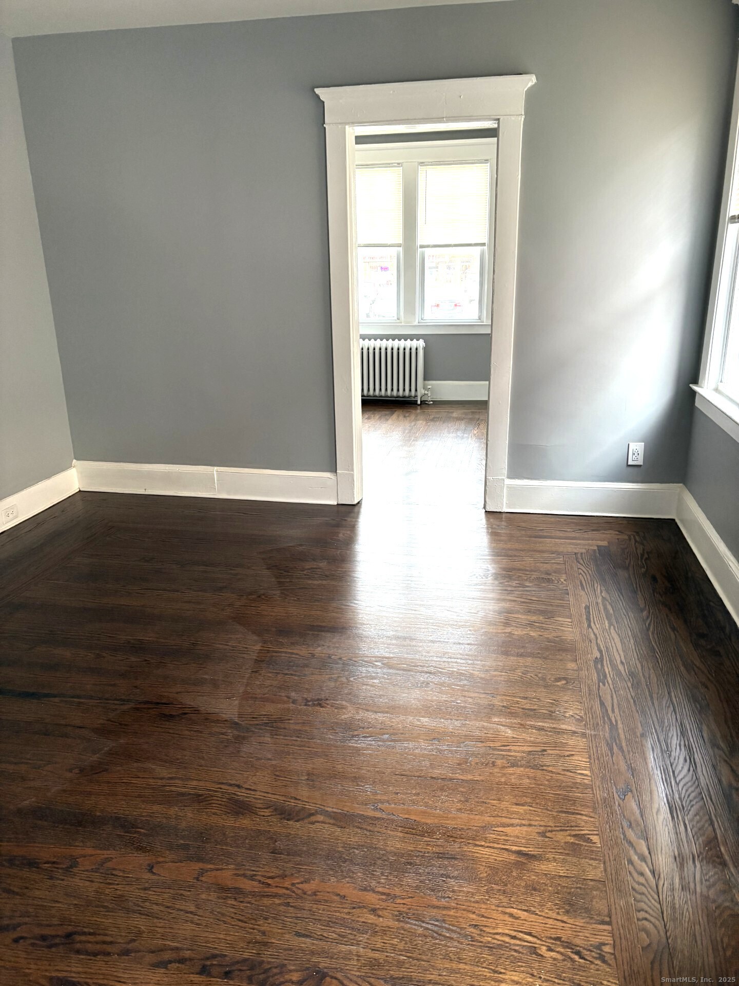 116 Elm Street West Haven, CT 06516 - Photo 8 of 14 a view of an empty room with wooden floor and a window