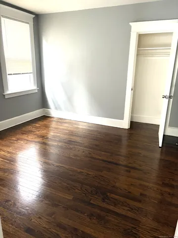 a bathroom with a toilet and a window