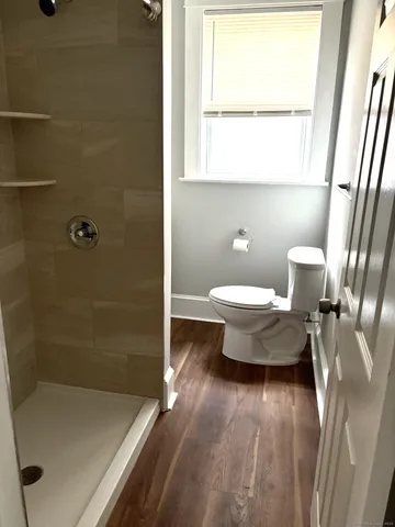 a view of a room with wooden floor and a window