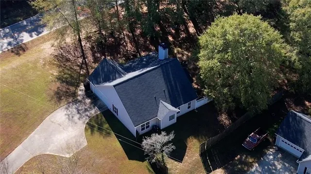 an aerial view of a house with a yard and garden