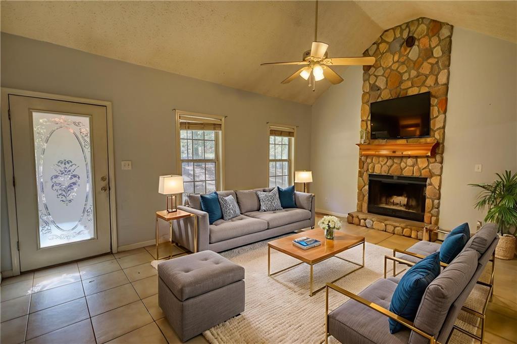 55 Ashland Farm Road Oxford, GA 30054 - Photo 14 of 55 a living room with furniture a flat screen tv and a fireplace